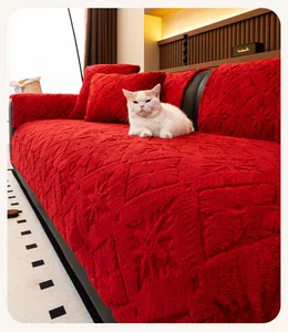 Detail of red plush sofa cover with star pattern texture and matching pillow