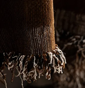 Detail of premium brown chenille sofa cover fabric with elegant tri-color fringe trim