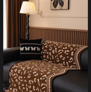 Close-up of brown leopard print chenille sofa cover with butterfly embroidery pillow