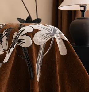 Close-up of thick chenille sofa cover with floral patterns and natural drape texture