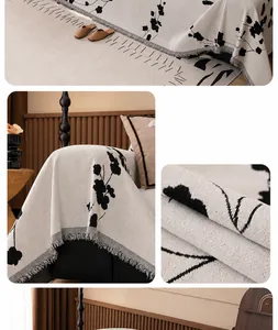 Close-up of white chenille sofa cover with black branch pattern and fringe edges