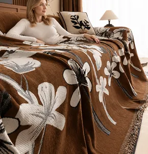 Detail of machine washable chenille sofa cover with floral jacquard and fringe edges