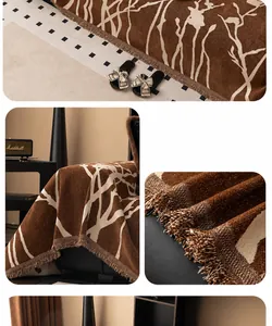 Detail of coffee chenille sofa cover showing white branch pattern and delicate fringe edge