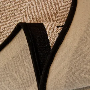 Nonslip chenille sofa cover with herringbone pattern and protective black binding