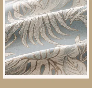 Macro detail of French vintage blue chenille fabric with tropical leaf jacquard pattern