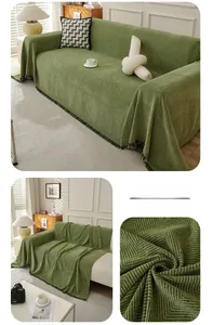 Detail of green herringbone sofa cover featuring textured fabric and delicate fringe edges