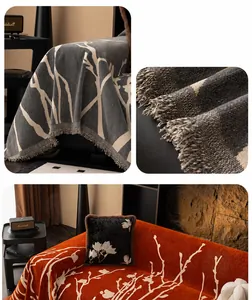 Detail of chenille sofa cover with artistic tree branch pattern and long fringe edges