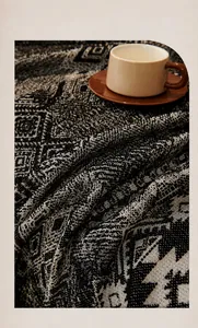 Detail of soft chenille sofa cover with black and white geometric jacquard pattern