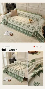 Macro view of sage green bohemian cotton knit sofa cover with fringe detail and patterns