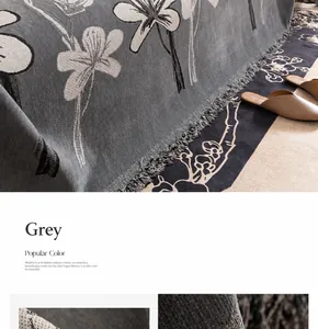 Macro shot of grey chenille sofa cover showing floral pattern and fringe tassels