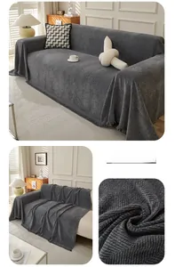Close-up of deep gray herringbone pattern sofa cover with fine decorative tassels