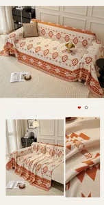 Close-up of bohemian orange jacquard sofa cover with geometric patterns and fringe detail