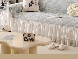Detail of blue chenille sofa cover with palm leaf print and double ruffle hem