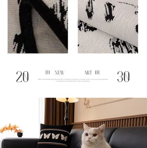 Detailed close-up of butterfly embroidery and chenille texture on luxury black sofa cushion