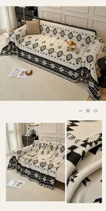 Close-up of bohemian black geometric patterns and fringe on knit cotton sofa throw blanket