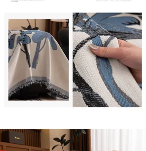Close-up of chenille floral sofa cover fabric texture with elegant blue fringe tassels