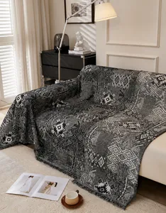 Close-up of double-sided bohemian chenille sofa cover with tassels and geometric patterns