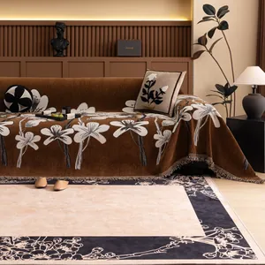 Retro chenille sofa cover with floral patterns and fringe edges in a cozy living room
