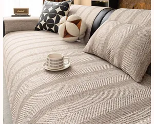 Detailed view of beige and brown herringbone woven sofa cushion and matching pillow