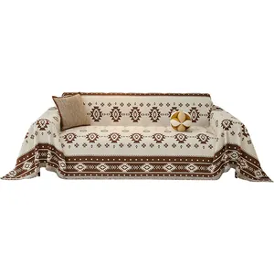 Jeté de canapé bohème à motifs géométriques avec pompons tissés en crème et marron