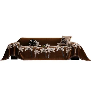 Vintage chenille sofa cover with white floral pattern and decorative fringe edges