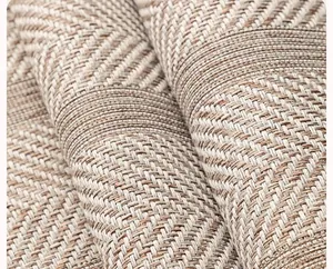 Detailed macro view of woven herringbone and checkered pattern on beige sofa cushion mat