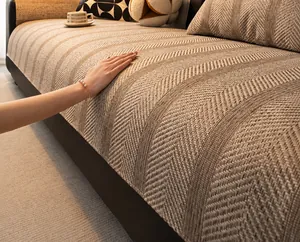 Detail of oatmeal herringbone sofa cover showing rich and thick fabric texture