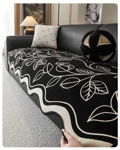 Close-up of thick chenille sofa cover showing wavy edge detail and leaf pattern