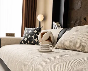 Detailed texture of beige linen sofa cover with anti-slip twill weave on leather sofa