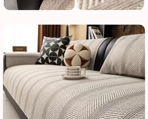 Detail of grey striped sofa cover with thick woven texture on a dark leather couch