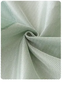 Close-up of light green ice silk sofa cover fabric with breathable honeycomb mesh texture