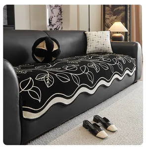 Detail of chenille sofa cover with white floral pattern and elegant wavy edges