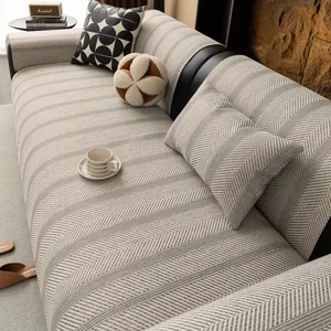 Japanese style gray herringbone woven sofa cover and matching pillow on a black couch