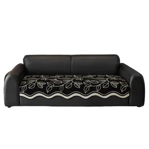 Chenille vintage sofa cushion with white vine embroidery and wavy edges on black leather