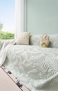 Detail of mint green ice silk sofa cover with embossed feather texture and cool fiber