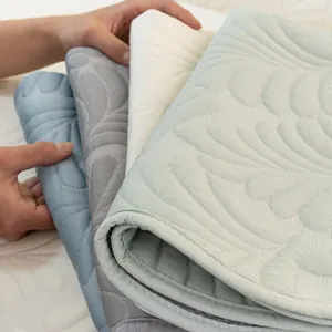 Quilted cooling ice silk sofa covers in soft pastel colors with leaf texture