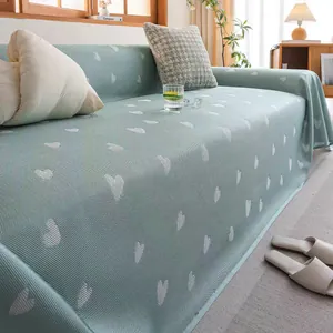 Detail of mint green summer cooling sofa cover with white heart patterns and mesh texture
