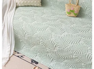 Close-up of light green ice silk sofa mat featuring leaf-shaped embossed texture