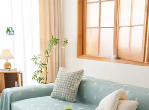 Detail of light green cool ice silk sofa cover featuring white cloud patterns and cooling fabric