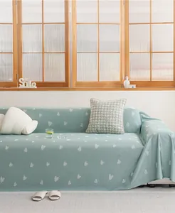 Detail of mint green summer cooling sofa cover with white heart pattern and breathable fabric