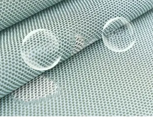 Detailed macro shot of light blue breathable mesh fabric with a diamond texture pattern