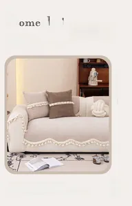 Detailed view of beige chenille sofa cushion featuring wave edges and decorative tassels