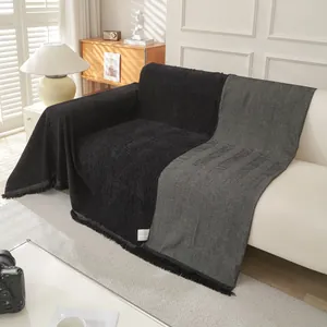 Universal black herringbone sofa cover with textured fabric and elegant fringe tassels