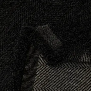 Extra wide black herringbone sofa cover with decorative tassels and thick textured fabric