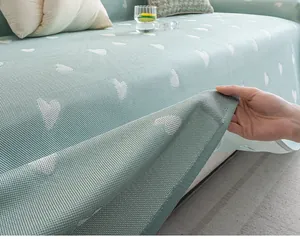 Detail of light green cooling sofa cover with white heart jacquard and mesh texture
