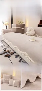 Detail of beige washed cotton sofa cover with elegant tassel lace edges and soft fabric texture