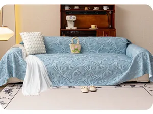 Close-up of light blue ice silk sofa cover with leaf pattern quilting and smooth texture