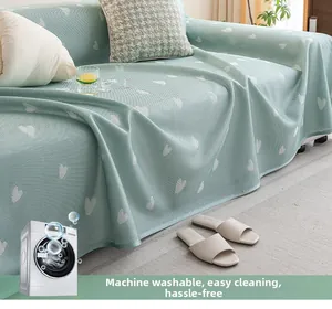 Detail of mint green heart-patterned sofa cover showing breathable knit fabric texture