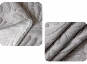 Close-up of grey cooling ice silk sofa cover featuring quilted leaf texture and fine seams