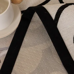 Modern minimalist black and white chenille sofa mat with non-slip backing and texture
